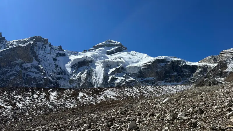 Snow-covered Adi Kailash peak above a moraine field