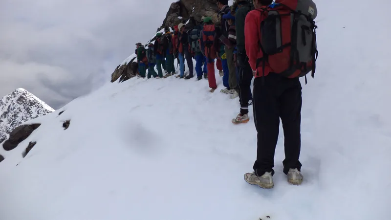 Trekkers walking a snowbound ridge in the Darma valley