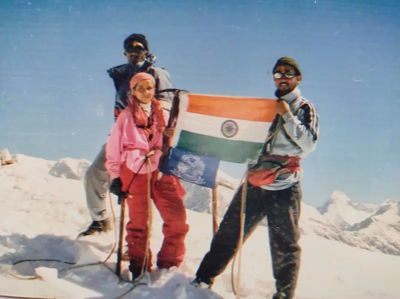 Climbers holding the Indian flag on a snow summit